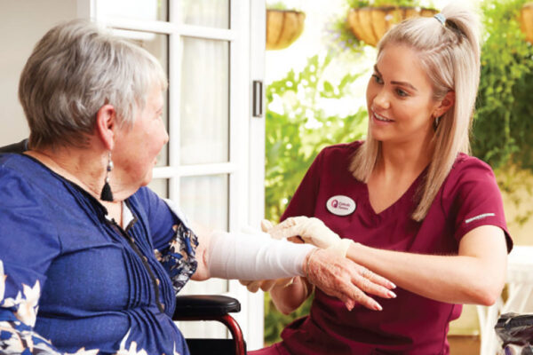 Nurse assisting a lady at home