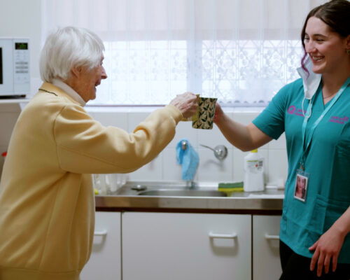 Care worker enjoy coffee with her client