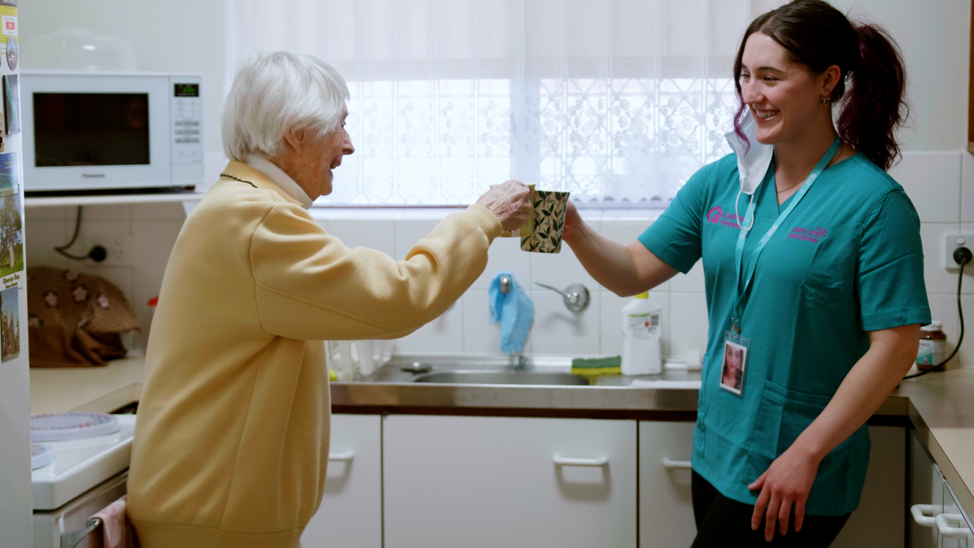 Care worker enjoy coffee with her client