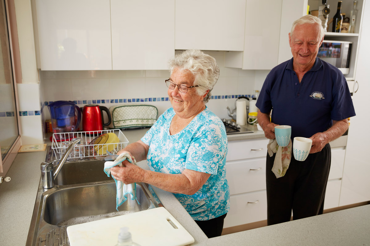 Trinity Independent Living resident cleaning dishes