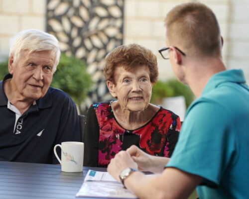 Home Care worker talking through private home care services with clients