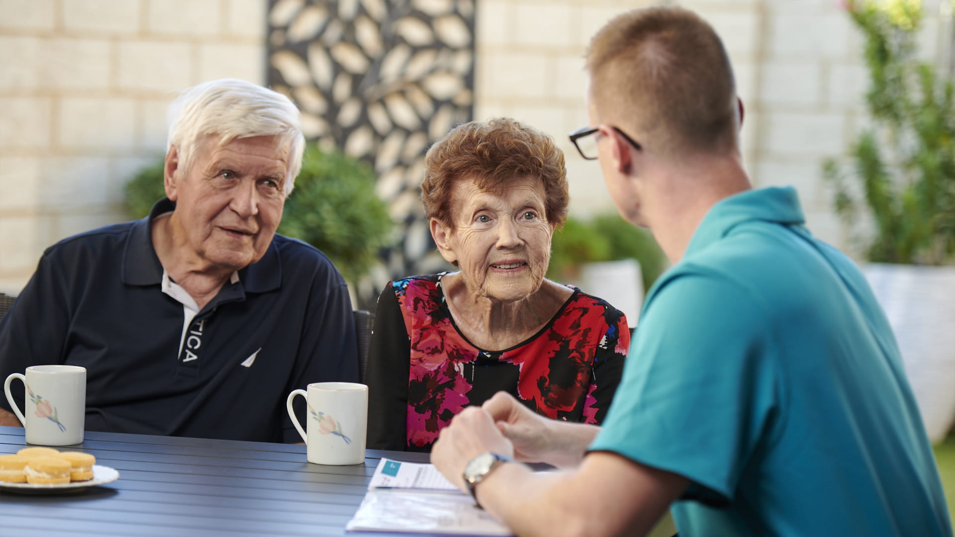 Home Care worker talking through private home care services with clients