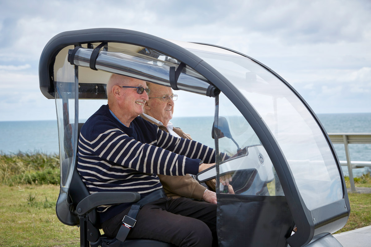 Residents at Ocean Star Independent Living Village take a gopher for a ride along the beach