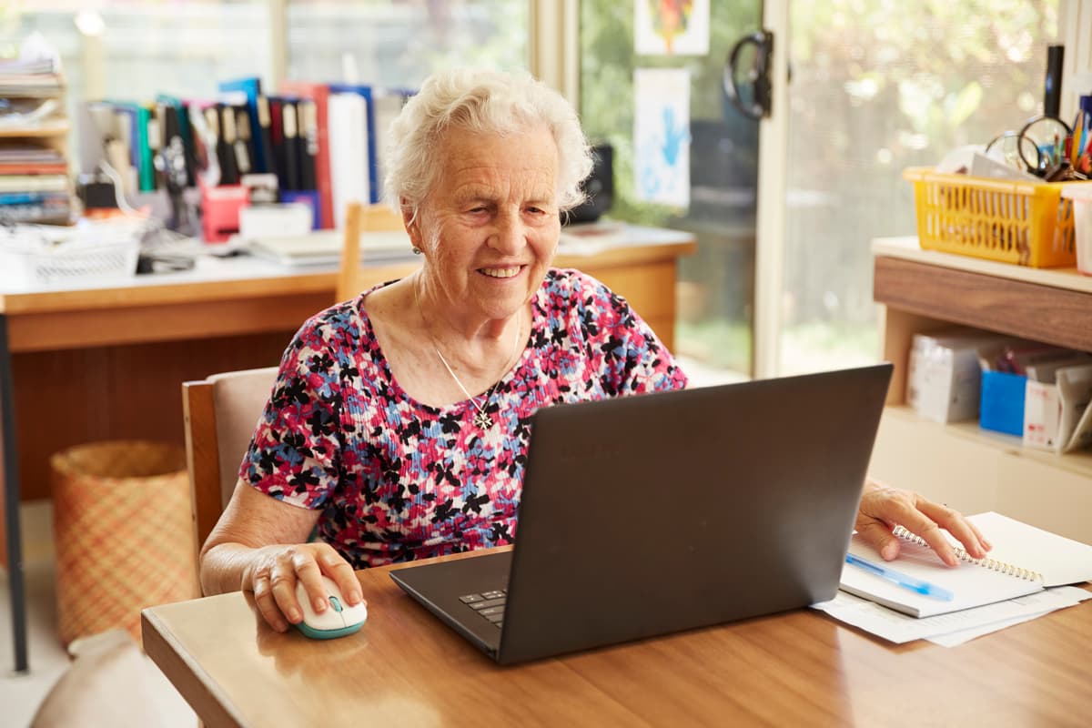 Lady on her computer receiving Home Care support with Catholic Homes