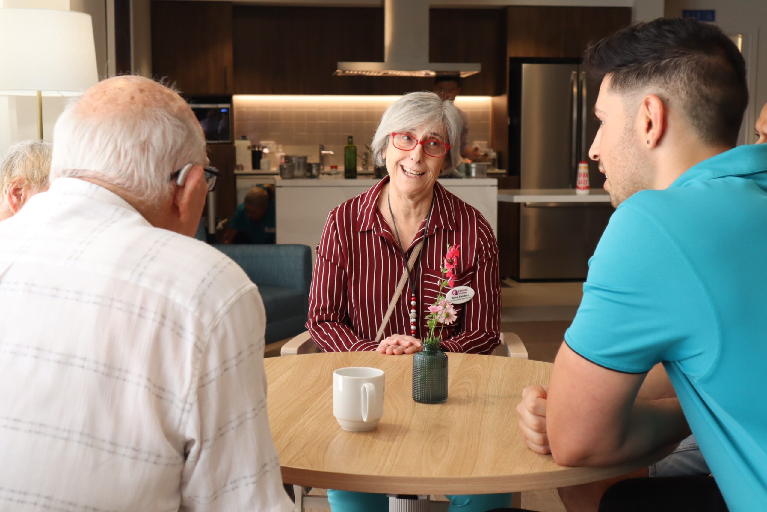 Care workers chat with clients at Catholic Homes