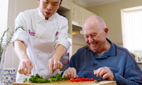 Catholic Homes Chef Harris helps prepare a meal in a client's home