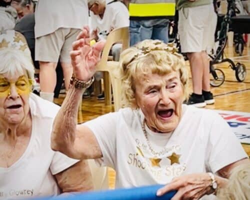 There was no shortage of colour, laughter, and community spirit when Catholic Homes residents from Sister Mary Glowrey, Archbishop Goody, and St Vincent’s took part in the 2025 LiveLighter Aged Care Games at Belmont Oasis Leisure Centre, presented by the Seniors Recreation Council of WA. The Games give older people in care the chance to enjoy team participation, friendly competition, and social connection through adapted games, and this year, Catholic Homes teams made their mark. St Vincent’s won Best Dressed, Sister Mary Glowrey claimed third place, and Archbishop Goody brought plenty of enthusiasm to the arena. For Shirley from Sister Mary Glowrey, it was an unforgettable experience. Having never participated in anything like this before, she embraced the opportunity with open arms. Her family were so proud they were talking about her efforts in the family group chat, and Shirley returned home with not only great memories but new friendships—meeting residents from other floors for the first time. Shirley’s daughter Denise shared her appreciation, “The feedback and photos brought tears to my eyes and made my heart swell in thanks to you all. It seems all who attended and participated enjoyed themselves immensely.” Her son and daughter-in-law, Meg and Bryan, agreed, “It was wonderful to see everyone having a great time, competing and socialising with one another.” The day was a celebration of fun, friendship, and community, the very things Catholic Homes strives to nurture every day.